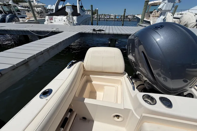 Slide: The Image of 2023 Grady-White Adventure 218 boat at dock, featuring Yamaha outboard motor. - 14