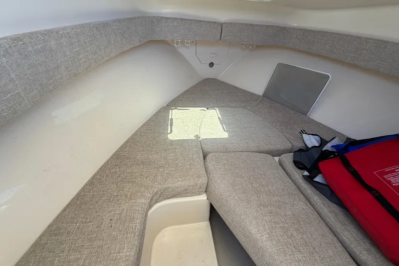 Slide: The Image of Interior cabin of 2023 Grady-White Adventure 218 boat, featuring cushioned seating. - 16