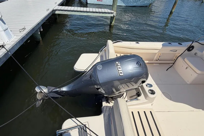 Slide: The Image of 2023 Grady-White Adventure 218 boat with Yamaha 200 outboard motor docked at marina. - 19