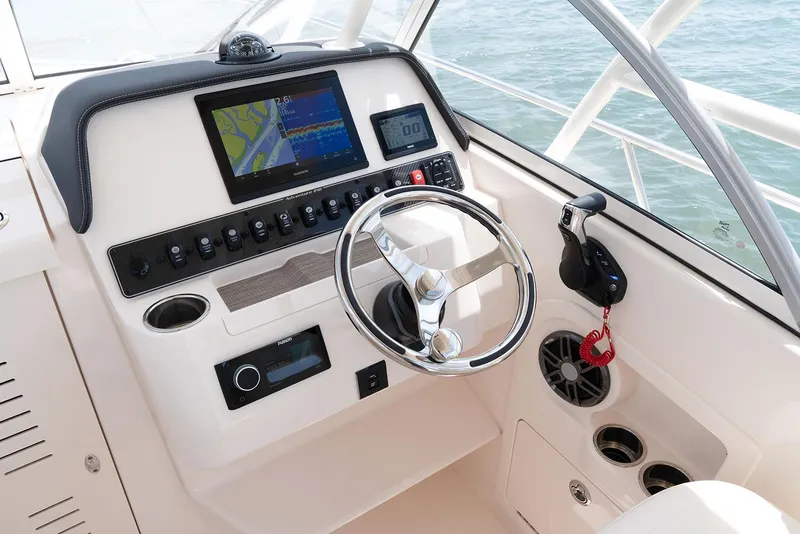Slide: The Image of Manufacturer Provided Image: 2023 Grady-White Adventure 218 helm with modern navigation system and controls. - 7
