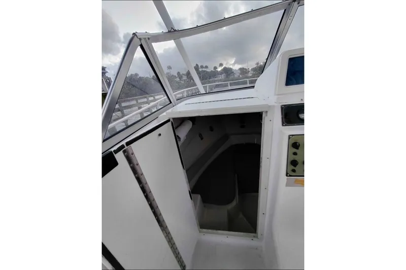 Slide: The Image of 2001 Key West 2300 Bluewater boat cabin interior with open hatch and control panel. - 3