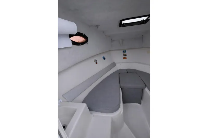 Slide: The Image of Interior of 2001 Key West 2300 Bluewater boat with seating and porthole. - 4