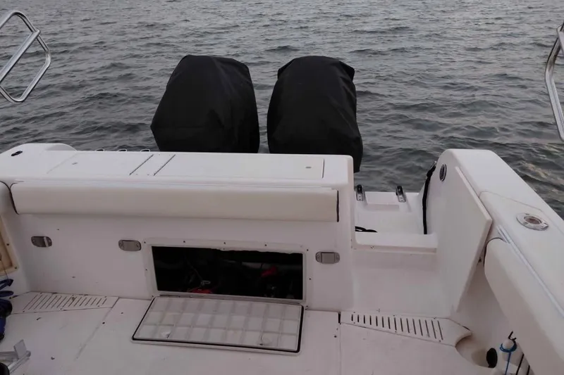 Slide: The Image of 2001 Key West 2300 Bluewater boat with covered engines on calm water. - 8