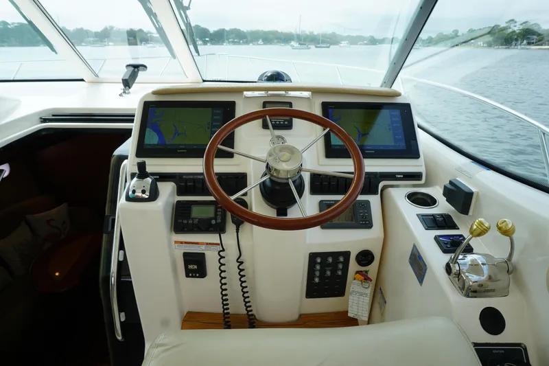 Slide: The Image of 2007 Tiara Yachts 3900 Sovran helm with dual navigation screens and wooden steering wheel. - 10
