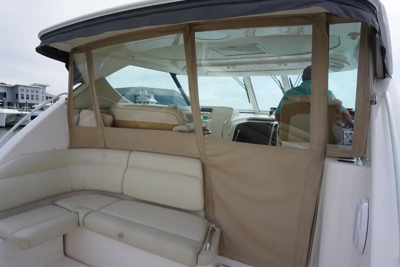 Slide: The Image of 2007 Tiara Yachts 3900 Sovran interior with beige seating and clear enclosure. - 13