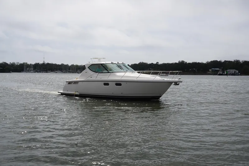 Slide: The Image of 2007 Tiara Yachts 3900 Sovran cruising on a calm lake under cloudy skies. - 24
