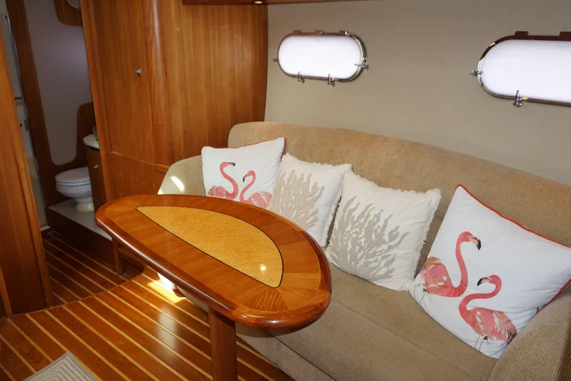 Slide: The Image of 2007 Tiara Yachts 3900 Sovran interior with elegant wood finish and decorative pillows. - 3