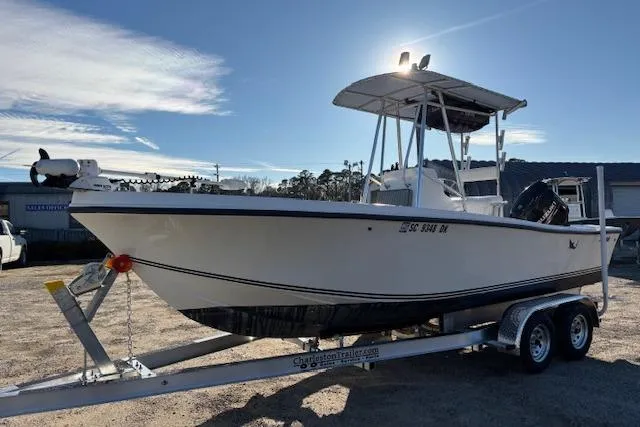 Slide: The Image of 1984 Mako 221 Center Console boat on trailer under clear sky. - 11