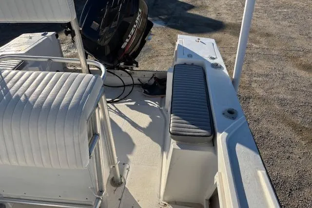 Slide: The Image of 1984 Mako 221 Center Console boat interior with seating and outboard motor. - 14