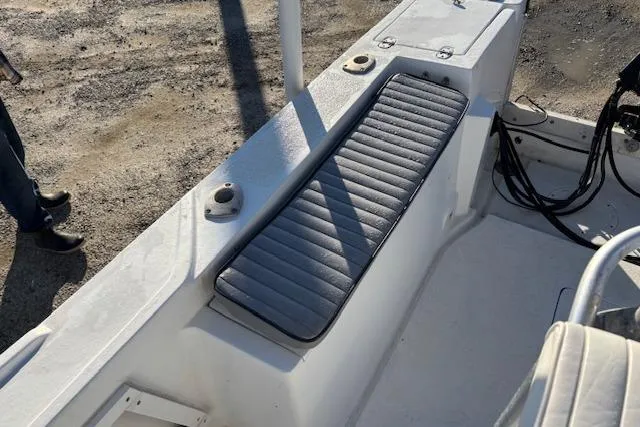 Slide: The Image of 1984 Mako 221 Center Console boat interior with cushioned seating and control cables. - 15