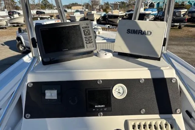 Slide: The Image of 1984 Mako 221 Center Console boat dashboard with Simrad and Suzuki electronics. - 18