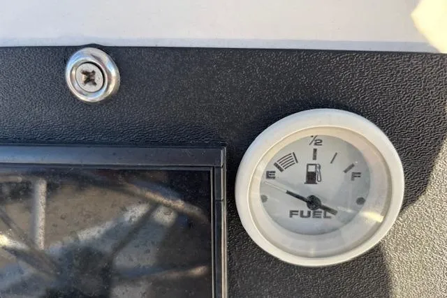 Slide: The Image of Fuel gauge on 1984 Mako 221 Center Console boat dashboard, showing near empty. - 20
