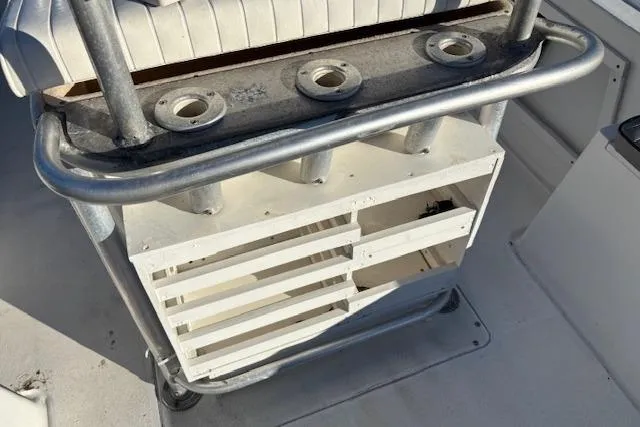 Slide: The Image of 1984 Mako 221 Center Console boat with rod holders and storage compartments. - 22