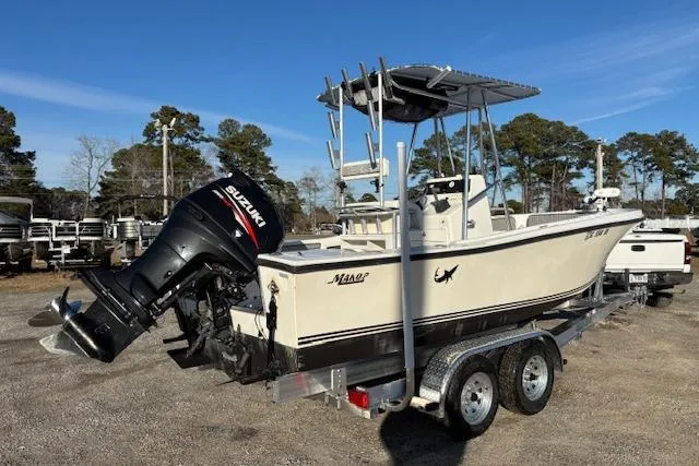 Slide: The Image of 1984 Mako 221 Center Console boat with Suzuki outboard motor on a trailer. - 3