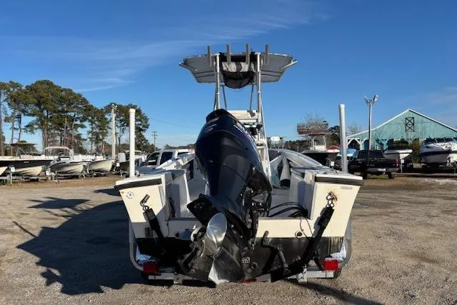 Slide: The Image of 1984 Mako 221 Center Console boat with outboard motor in a marina setting. - 8