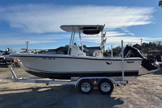 Slide: The Image of 1984 Mako 221 Center Console boat on trailer, side view under clear sky. - 10