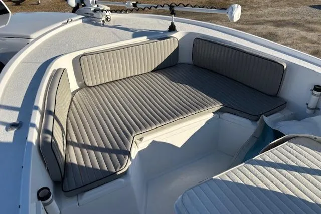 Slide: The Image of 1984 Mako 221 Center Console boat with cushioned seating in the bow area. - 12