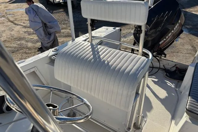 Slide: The Image of 1984 Mako 221 Center Console boat interior with white seating and steering wheel. - 13