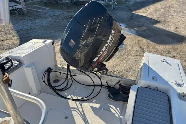 Slide: The Image of 1984 Mako 221 Center Console with Suzuki outboard motor, docked on a sunny day. - 21