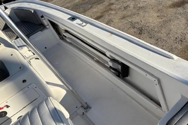 Slide: The Image of 1984 Mako 221 Center Console boat interior with seating and storage compartments. - 24