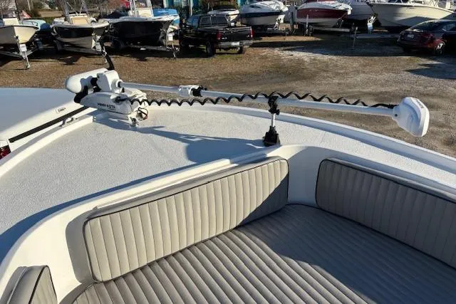 Slide: The Image of 1984 Mako 221 Center Console boat with trolling motor and cushioned seating. - 26
