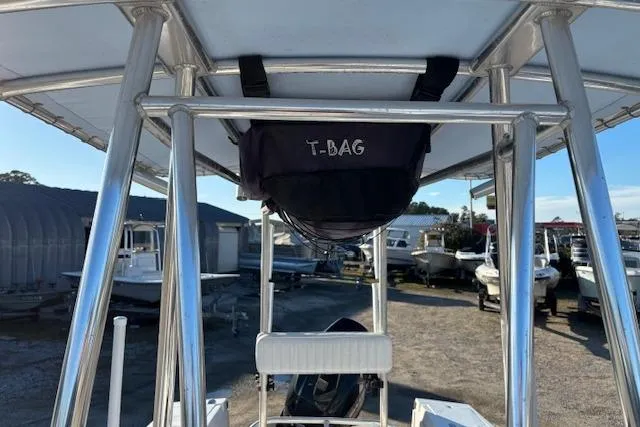 Slide: The Image of 1984 Mako 221 Center Console with T-top and T-bag storage, parked in a boatyard. - 27
