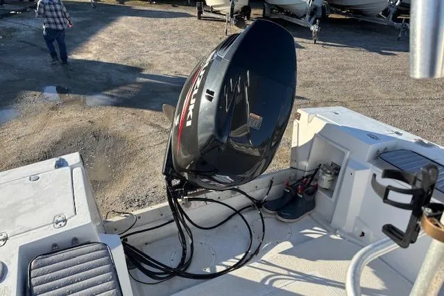 Slide: The Image of 1984 Mako 221 Center Console boat with outboard motor in a gravel lot. - 29