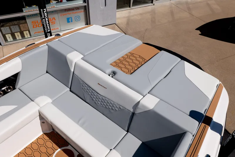 Slide: The Image of 2026 MasterCraft NXT24 boat interior with gray and tan seating, hexagonal pattern accents. - 12