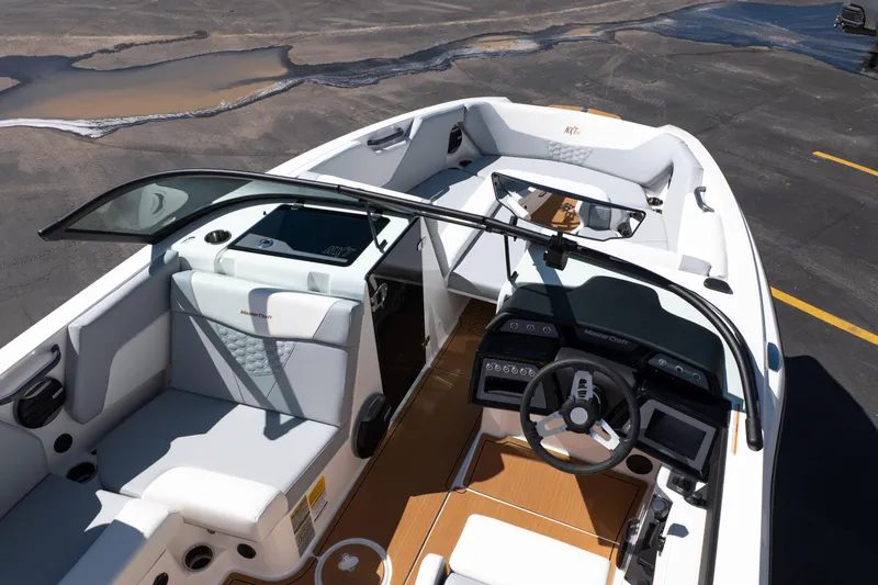 Slide: The Image of 2026 MasterCraft NXT24 boat interior with modern dashboard and seating. - 13