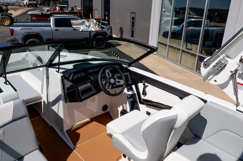 Slide: The Image of 2026 MasterCraft NXT24 boat interior with modern dashboard and seating. - 14