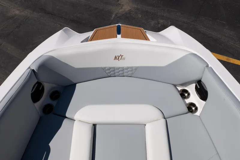 Slide: The Image of 2026 MasterCraft NXT24 boat interior with sleek seating and cup holders. - 15