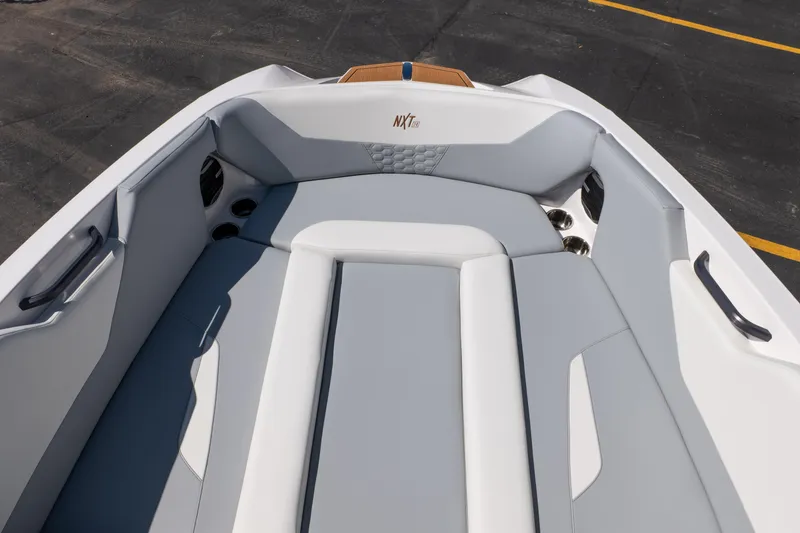 Slide: The Image of 2026 MasterCraft NXT24 boat interior with sleek gray seating and cup holders. - 16