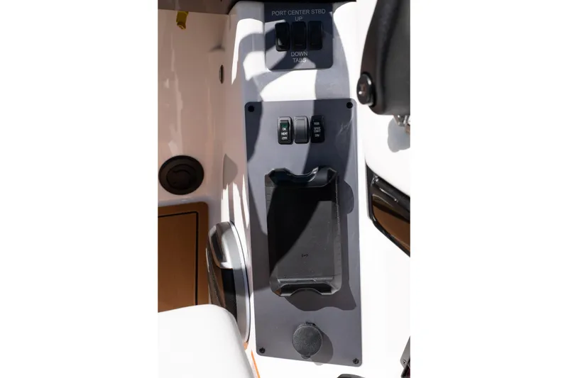Slide: The Image of 2026 MasterCraft NXT24 boat control panel with switches and holder. - 30