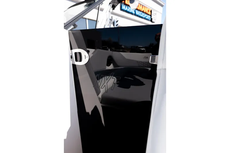 Slide: The Image of 2026 MasterCraft NXT24 boat interior with sleek black panel and modern design. - 33