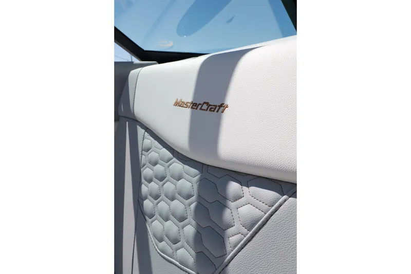 Slide: The Image of 2026 MasterCraft NXT24 interior with embossed logo and hexagonal pattern design. - 34