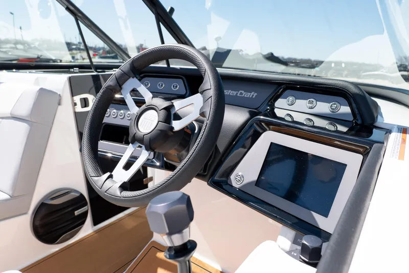 Slide: The Image of 2026 MasterCraft NXT24 boat dashboard with steering wheel and touchscreen controls. - 35