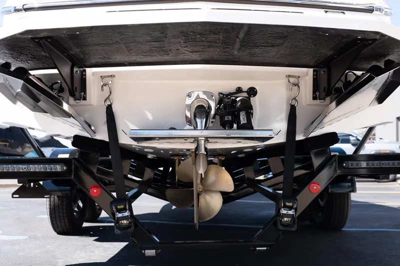 Slide: The Image of Rear view of 2026 MasterCraft NXT24 boat on trailer, showcasing propeller and hull design. - 4