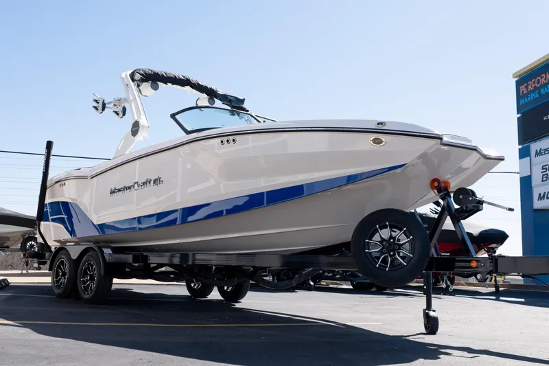 Slide: The Image of 2026 MasterCraft NXT24 boat on trailer, showcasing sleek design and modern features. - 7
