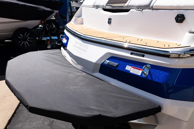 Slide: The Image of 2026 MasterCraft NXT24 boat rear view with swim platform and blue accents. - 8