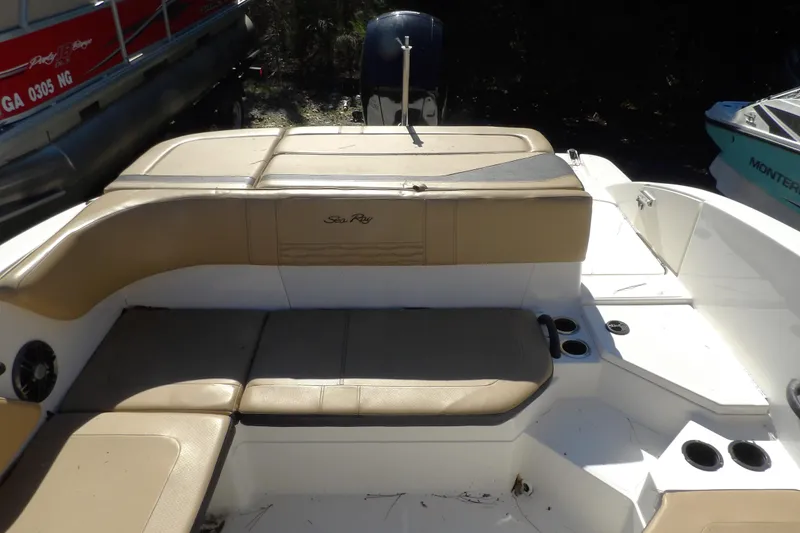 Slide: The Image of 2023 Searay 210 SPO boat interior with tan seating and cup holders. - 4