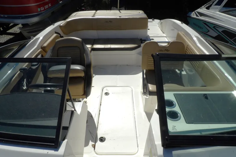 Slide: The Image of 2023 Searay 210 SPO boat interior with seating and steering wheel. - 7