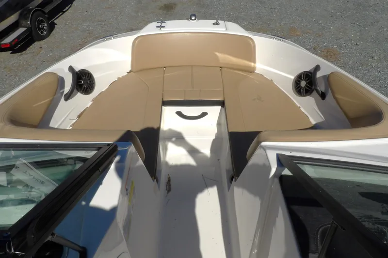 Slide: The Image of 2023 Searay 210 SPO boat interior with tan seating and speakers. - 8