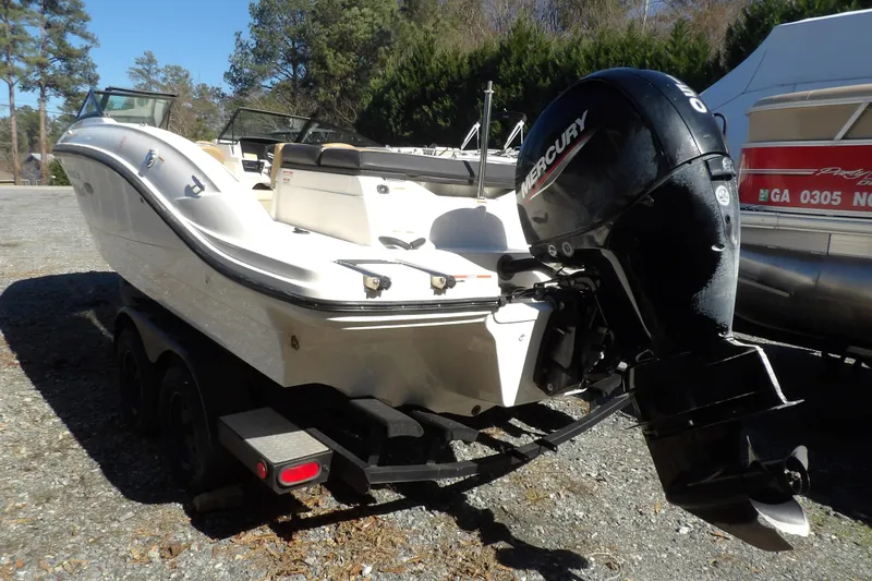 Slide: The Image of 2023 Searay 210 SPO boat with Mercury outboard engine on trailer. - 9