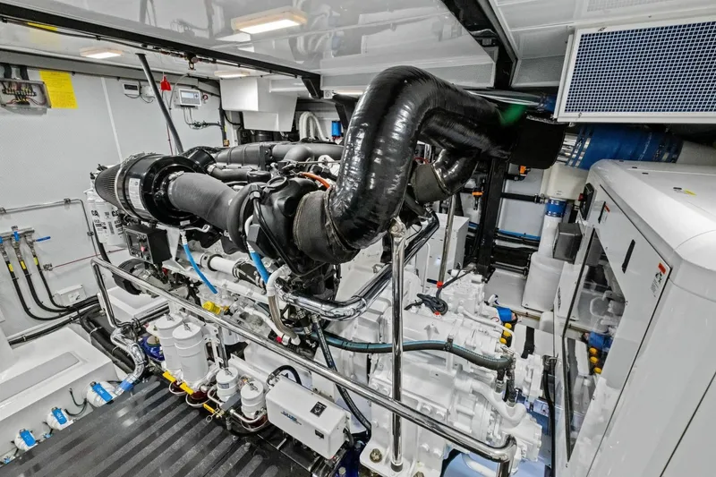 Slide: The Image of Engine room of 2024 Marlow 90 V yacht, showcasing advanced machinery and piping systems. - 103