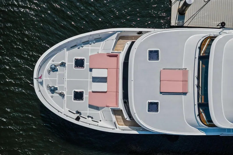 Slide: The Image of Top view of 2024 Marlow 90 V yacht docked, featuring spacious deck and seating. - 107