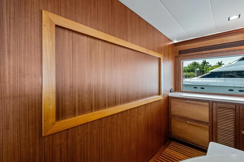 Slide: The Image of Interior of 2024 Marlow 90 V yacht with wooden paneling and window view. - 15