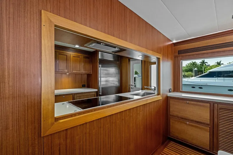 Slide: The Image of Luxurious 2024 Marlow 90 V yacht interior with wooden cabinetry and modern kitchen design. - 16