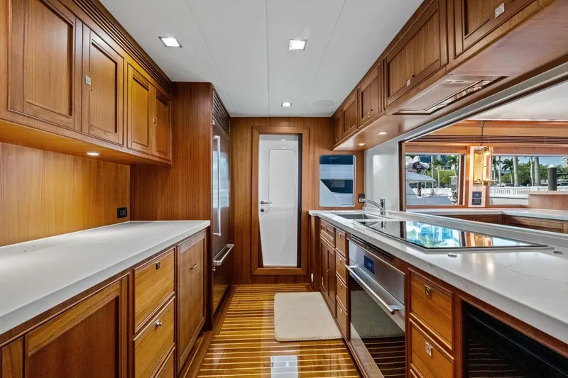 Slide: The Image of Luxurious kitchen interior of 2024 Marlow 90 V yacht with wooden cabinetry and modern appliances. - 18