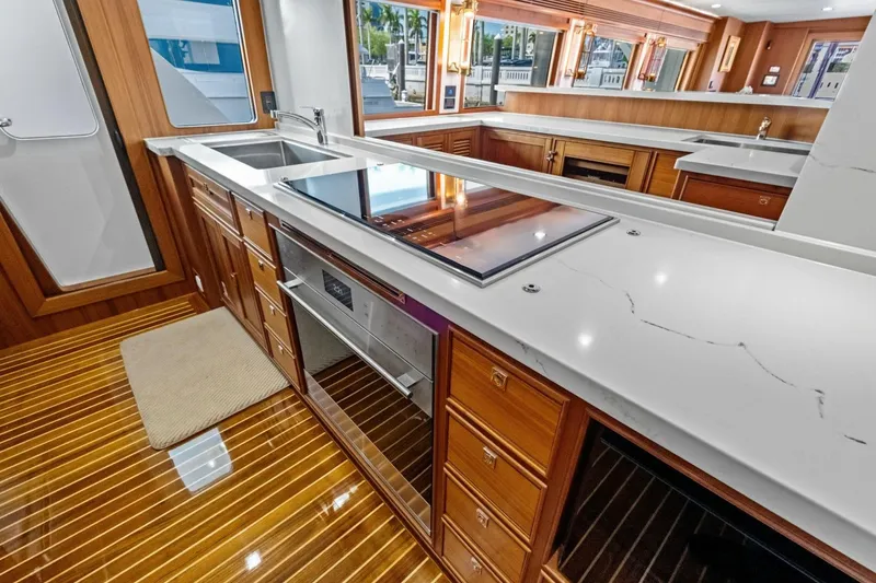 Slide: The Image of Luxurious kitchen interior of 2024 Marlow 90 V yacht with modern appliances and wooden cabinetry. - 19