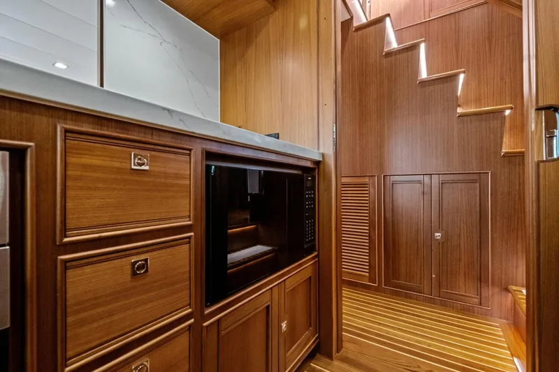 Slide: The Image of Luxurious wood interior of 2024 Marlow 90 V yacht with modern cabinetry and staircase. - 20